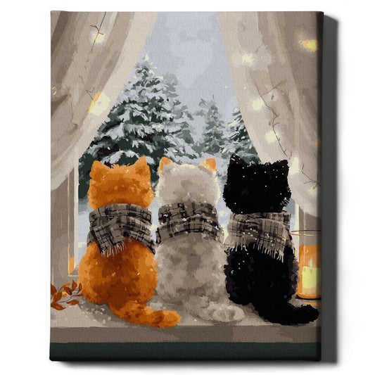 Trzy kociaki przy oknie